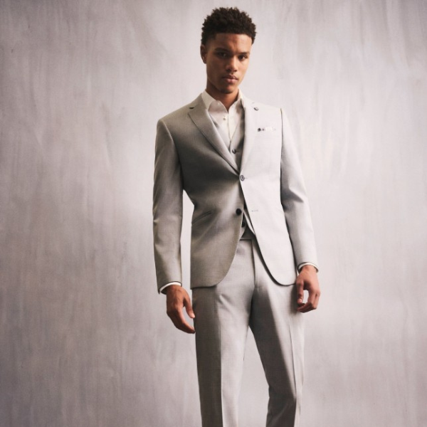 Model wearing a stone-coloured Uberstone suit