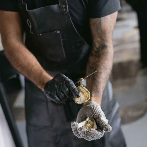 Live oyster shucker at the couple's rooftop wedding reception