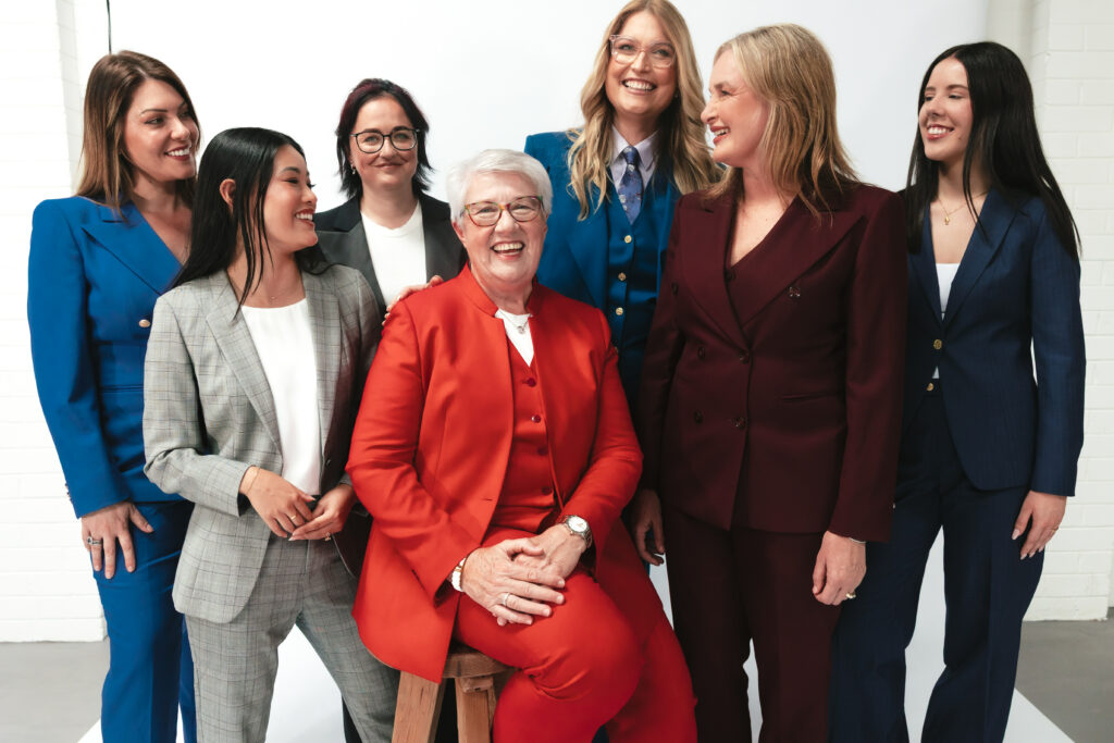Women pose in their made-to-measure suits